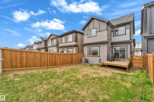 Private backyard featuring a natural wood fence and a ground-level wood deck - 17319 2 St Nw, Edmonton, AB - Outdoor