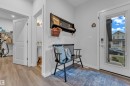 Entryway featuring wood-finish flooring, white trim, and a full-light door with integrated smart lock - 17319 2 St Nw, Edmonton, AB  - Indoor Photo Showing Other Room 