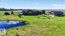 The property features a primary residence with an attached double garage, a detached garage, and a paved driveway - 531064 Range Road 174, Rural Lamont County, AB  - Outdoor With Facade 