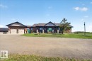 The property features a multi-level deck with a spiral staircase, a hot tub, and a detached structure with large windows - 531064 Range Road 174, Rural Lamont County, AB  - Outdoor With Deck Patio Veranda 