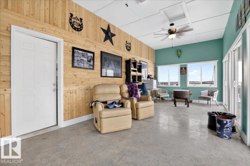 This property features a spacious detached garage with three garage doors and an additional outbuilding with a large garage door - 531064 Range Road 174, Rural Lamont County, AB - Outdoor