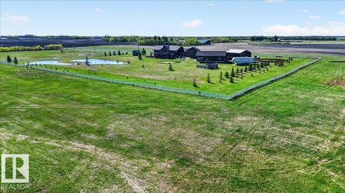 The spacious garage features high ceilings, exposed beams, and two large garage doors - 531064 Range Road 174, Rural Lamont County, AB - Indoor Photo Showing Garage
