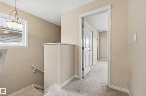 Carpeted hallway and staircase featuring light neutral wall tones - 2170 52A Street Sw, Edmonton, AB - Indoor Photo Showing Other Room