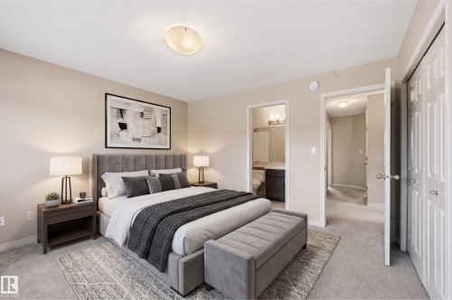 Carpeted bedroom featuring a flush-mount ceiling light and neutral wall paint - 2170 52A Street Sw, Edmonton, AB - Indoor Photo Showing Bedroom