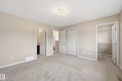 Carpeted room featuring neutral wall tones, white baseboards, and a flush mount ceiling light - 2170 52A Street Sw, Edmonton, AB - Indoor