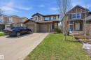 Two-story residence featuring a stone and stucco exterior, a dual garage, and a concrete driveway - 2170 52A Street Sw, Edmonton, AB  - Outdoor With Facade 