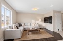 Living area featuring dark wood-finish flooring with a contrasting area rug - 2170 52A Street Sw, Edmonton, AB  - Indoor Photo Showing Living Room 