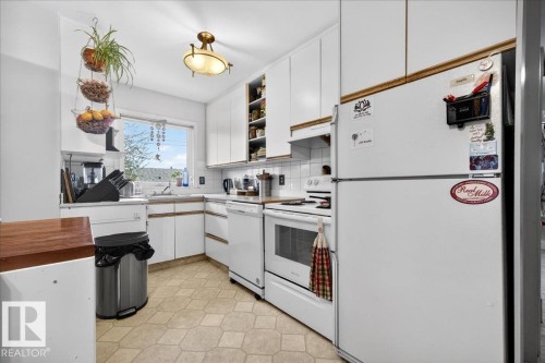 Bright kitchen featuring white cabinetry and appliances - 4212 105 Avenue, Edmonton, AB - Indoor Photo Showing Kitchen