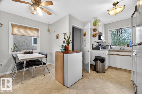 Kitchen featuring white cabinetry, a built-in sink, and light-toned geometric pattern flooring - 4212 105 Avenue, Edmonton, AB - Indoor