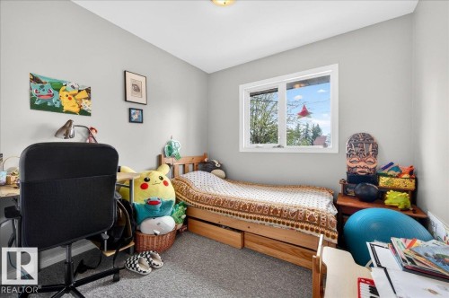 Bright room featuring a large window, light gray walls, and gray carpet flooring - 4212 105 Avenue, Edmonton, AB - Indoor Photo Showing Bedroom
