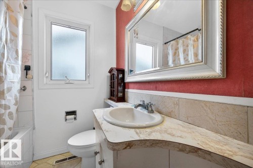 Bathroom vanity featuring a built-in sink and laminate countertop - 4212 105 Avenue, Edmonton, AB - Indoor Photo Showing Bathroom