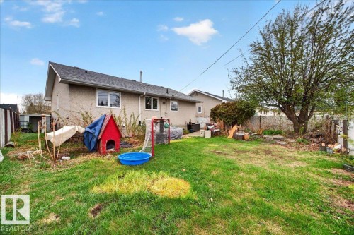 Expansive rear yard featuring green lawn space, a mature tree, and a fenced perimeter - 4212 105 Avenue, Edmonton, AB - Outdoor