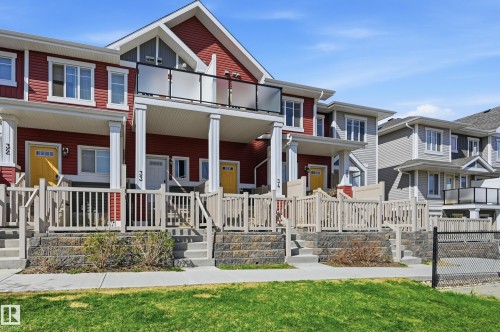 Contemporary townhome featuring a vibrant red siding facade - 34 2905 141 Street, Edmonton, AB - Outdoor With Facade