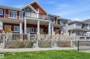 Contemporary townhome featuring a vibrant red siding facade - 34 2905 141 Street, Edmonton, AB  - Outdoor With Facade 