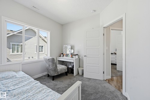 Plush grey carpeting complements the neutral wall tones - 34 2905 141 Street, Edmonton, AB - Indoor Photo Showing Bedroom