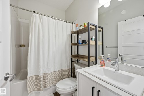 Bathroom featuring a white vanity with a rectangular basin sink and a light-toned countertop - 34 2905 141 Street, Edmonton, AB - Indoor Photo Showing Bathroom
