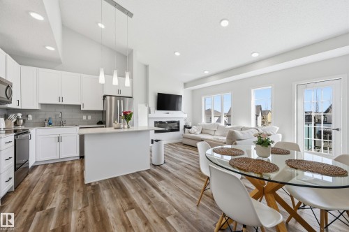 Open-concept living space with vaulted ceilings featuring wood-finish flooring - 34 2905 141 Street, Edmonton, AB - Indoor Photo Showing Other Room