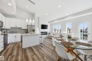Open-concept living space with vaulted ceilings featuring wood-finish flooring - 34 2905 141 Street, Edmonton, AB  - Indoor Photo Showing Other Room 