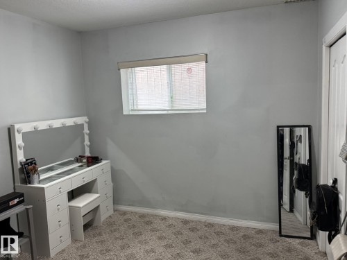 Light gray painted walls with a single window featuring blinds - 3139 34B Avenue, Edmonton, AB 