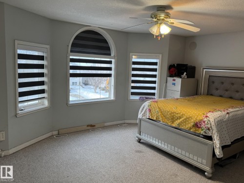 Bay window with arched transom, opaque window treatments, and wall-mounted ceiling fan - 3139 34B Avenue, Edmonton, AB 