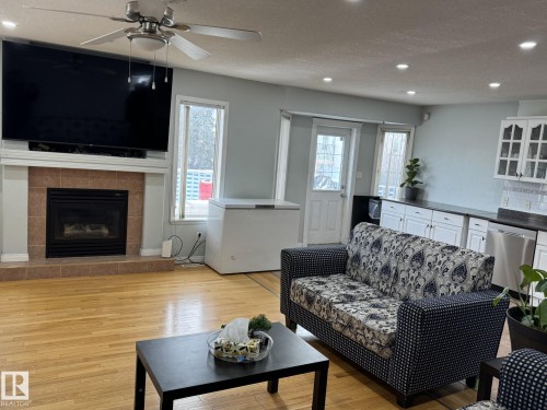Living area with wood-finish flooring and recessed lighting - 3139 34B Avenue, Edmonton, AB 