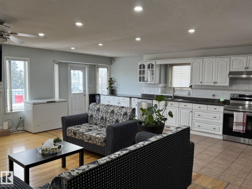 Open-concept living space featuring recessed lighting, a ceiling fan, and hardwood-finish flooring in the living area - 3139 34B Avenue, Edmonton, AB 