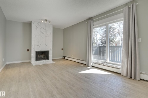 113 10838 108 Street, Edmonton, AB - Indoor Photo Showing Living Room With Fireplace