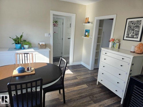 Spacious interior featuring wood-finish flooring, neutral wall tones, and white trim. - 4825 52 Street, Elk Point, AB - Indoor