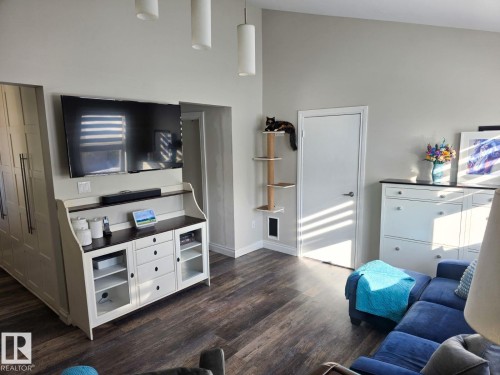 Vaulted ceilings complement the wood-finish flooring throughout this open living space. - 4825 52 Street, Elk Point, AB - Indoor