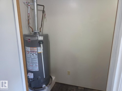 Water heater installation within an interior utility closet. - 4825 52 Street, Elk Point, AB - Indoor