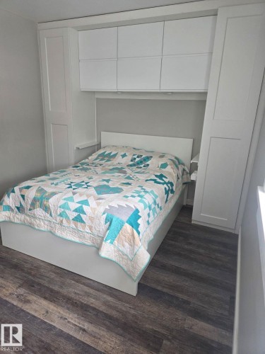 Integrated white cabinetry and shelving system with overhead storage and recessed lighting. - 4825 52 Street, Elk Point, AB - Indoor Photo Showing Bedroom
