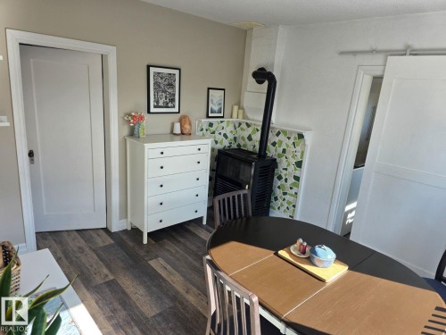 Distressed wood-finish flooring complements light-toned walls. - 4825 52 Street, Elk Point, AB - Indoor