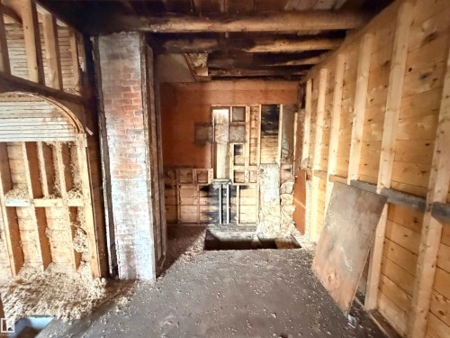Interior space presenting exposed framing, brick elements, and a visible subfloor - 5036 49 Street, Clyde, AB - Indoor