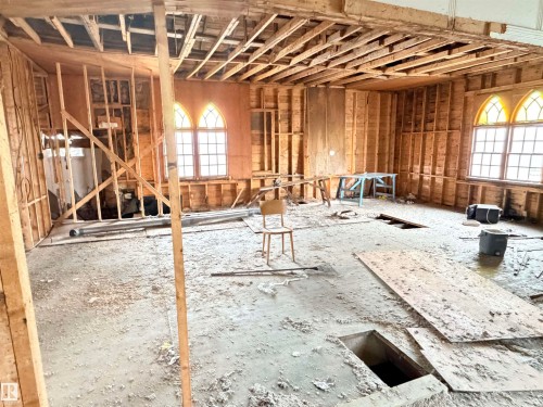 Interior space undergoing renovation, featuring exposed wood wall studs and ceiling joists - 5036 49 Street, Clyde, AB - Indoor