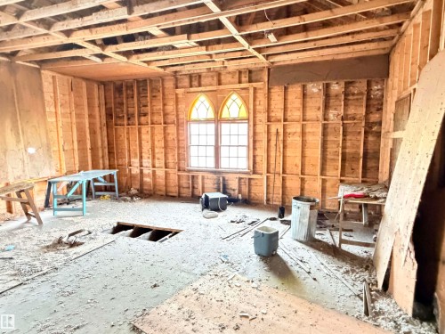 Interior space featuring exposed wood framing, an exposed ceiling with wood joists, and a partial subfloor - 5036 49 Street, Clyde, AB - Indoor