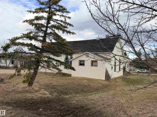 Stucco exterior with a pitched roof - 5036 49 Street, Clyde, AB - Outdoor