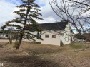 Stucco exterior with a pitched roof - 5036 49 Street, Clyde, AB  - Outdoor 