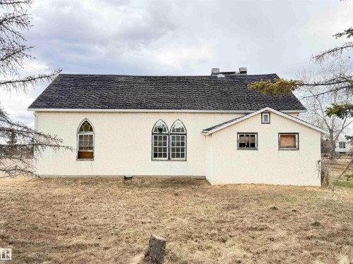 Stucco exterior with a pitched asphalt shingle roof - 5036 49 Street, Clyde, AB - Outdoor