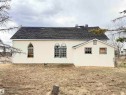 Stucco exterior with a pitched asphalt shingle roof - 5036 49 Street, Clyde, AB  - Outdoor 