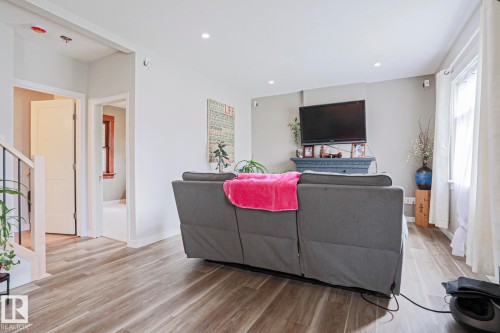 Living area featuring wood-finish flooring, recessed lighting, and a neutral color palette - 5113 53 Avenue, Stony Plain, AB - Indoor