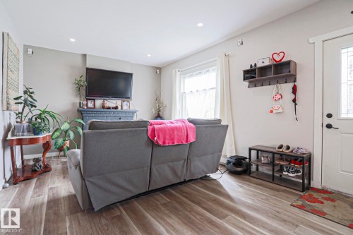 Living area with wood-finish flooring and recessed lighting - 5113 53 Avenue, Stony Plain, AB - Indoor