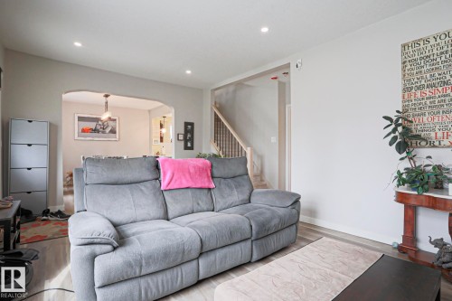 Living space featuring wood-finish flooring, recessed lighting, and a neutral color palette - 5113 53 Avenue, Stony Plain, AB - Indoor Photo Showing Living Room