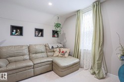 Recessed lighting illuminates a space featuring three wall-mounted display niches - 
