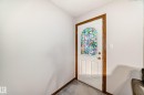 Entry door with an arched stained glass window and wood-finish trim - 9716 162 Street, Edmonton, AB  - Indoor Photo Showing Other Room 