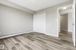 Bedroom featuring wood-finish flooring and neutral wall tones - 