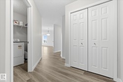 Hallway featuring wood-finish flooring and bi-fold panel doors - 