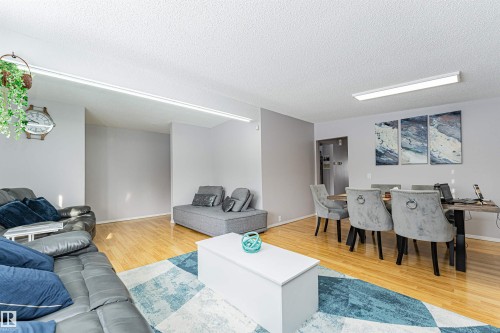Expansive living and dining area featuring wood-finish flooring - 10412 39 Avenue, Edmonton, AB - Indoor Photo Showing Living Room