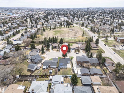 Aerial overview of a residential neighborhood with numerous detached homes, mature trees, and paved roads - 10412 39 Avenue, Edmonton, AB - Outdoor With View