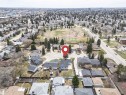 Aerial overview of a residential neighborhood with numerous detached homes, mature trees, and paved roads - 10412 39 Avenue, Edmonton, AB  - Outdoor With View 