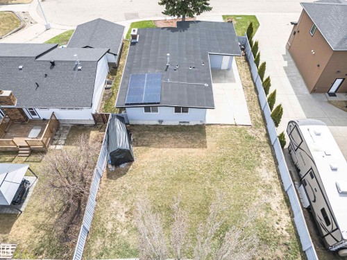 Property featuring solar panels, a fenced backyard, and a concrete patio - 10412 39 Avenue, Edmonton, AB - Outdoor